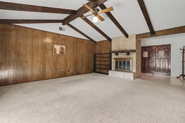 a view of a livingroom with furniture and staircase