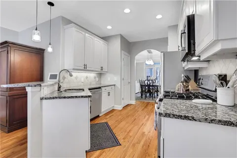 a dining room with furniture and wooden floor