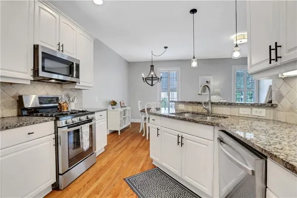 a living room with furniture and a kitchen view