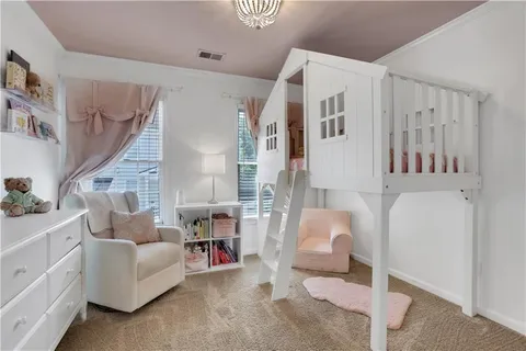 a view of a hallway with paintings on the wall