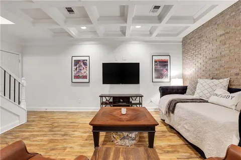 a living room with furniture and a table with wooden floor