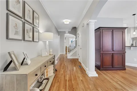 a living room with furniture and a chandelier