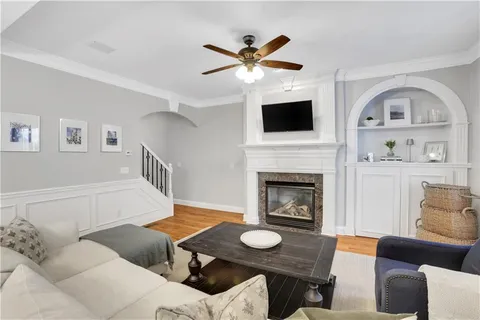 a living room with furniture a fireplace and a window