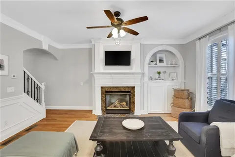 a living room with furniture and a chandelier