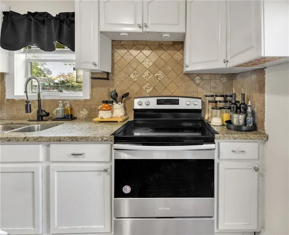 a stove top oven sitting inside of a kitchen