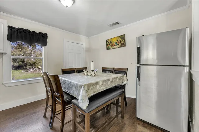 a dining room with a table and chairs