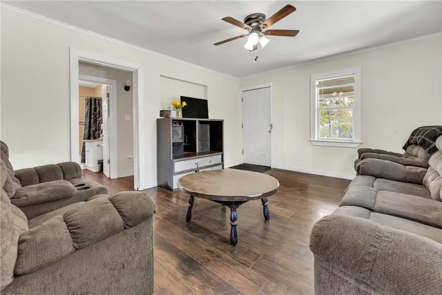 a living room with furniture a rug and a window