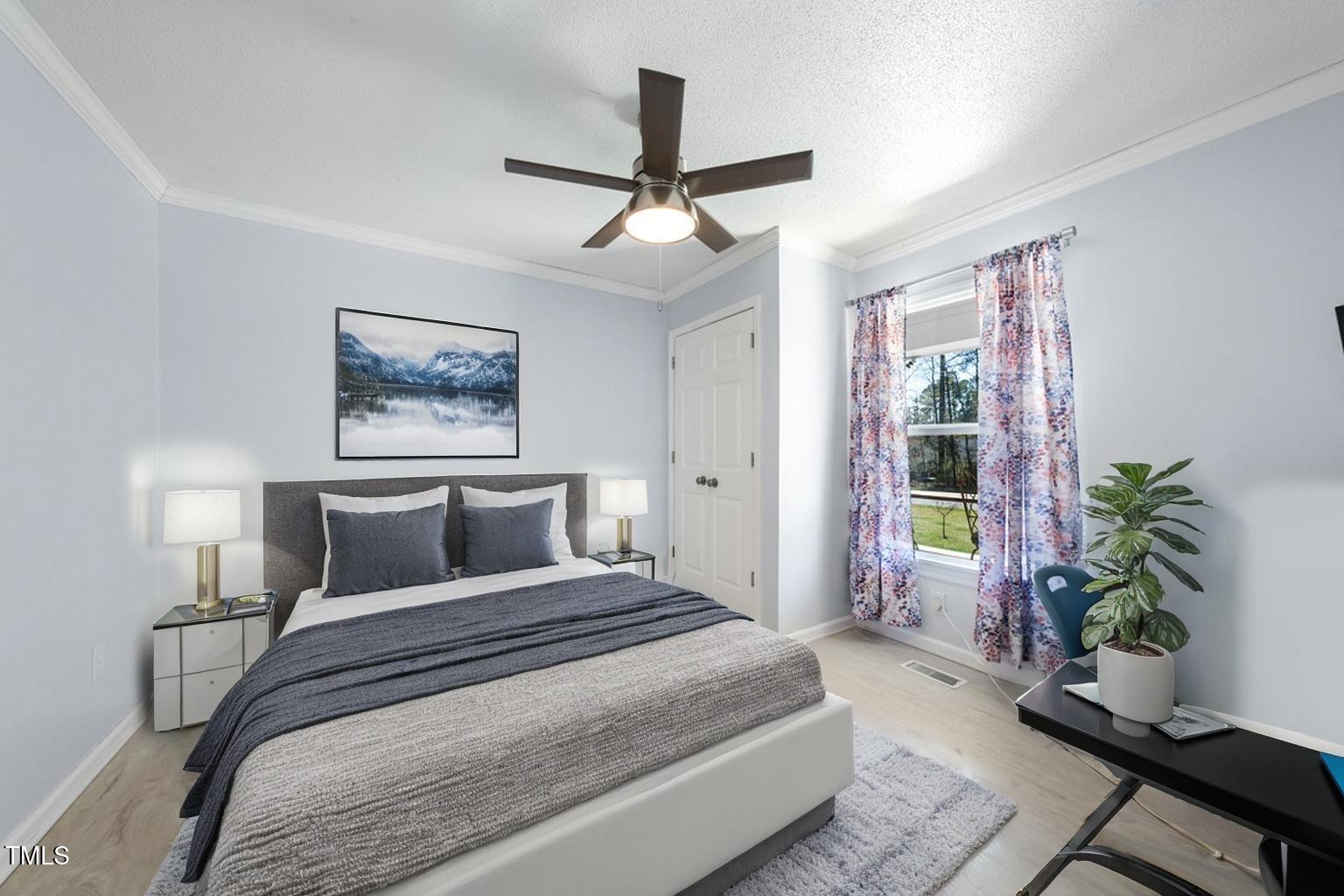 916 Clayton Road Durham, NC 27703 - Photo 11 of 32 a bedroom with a large bed and a potted plant