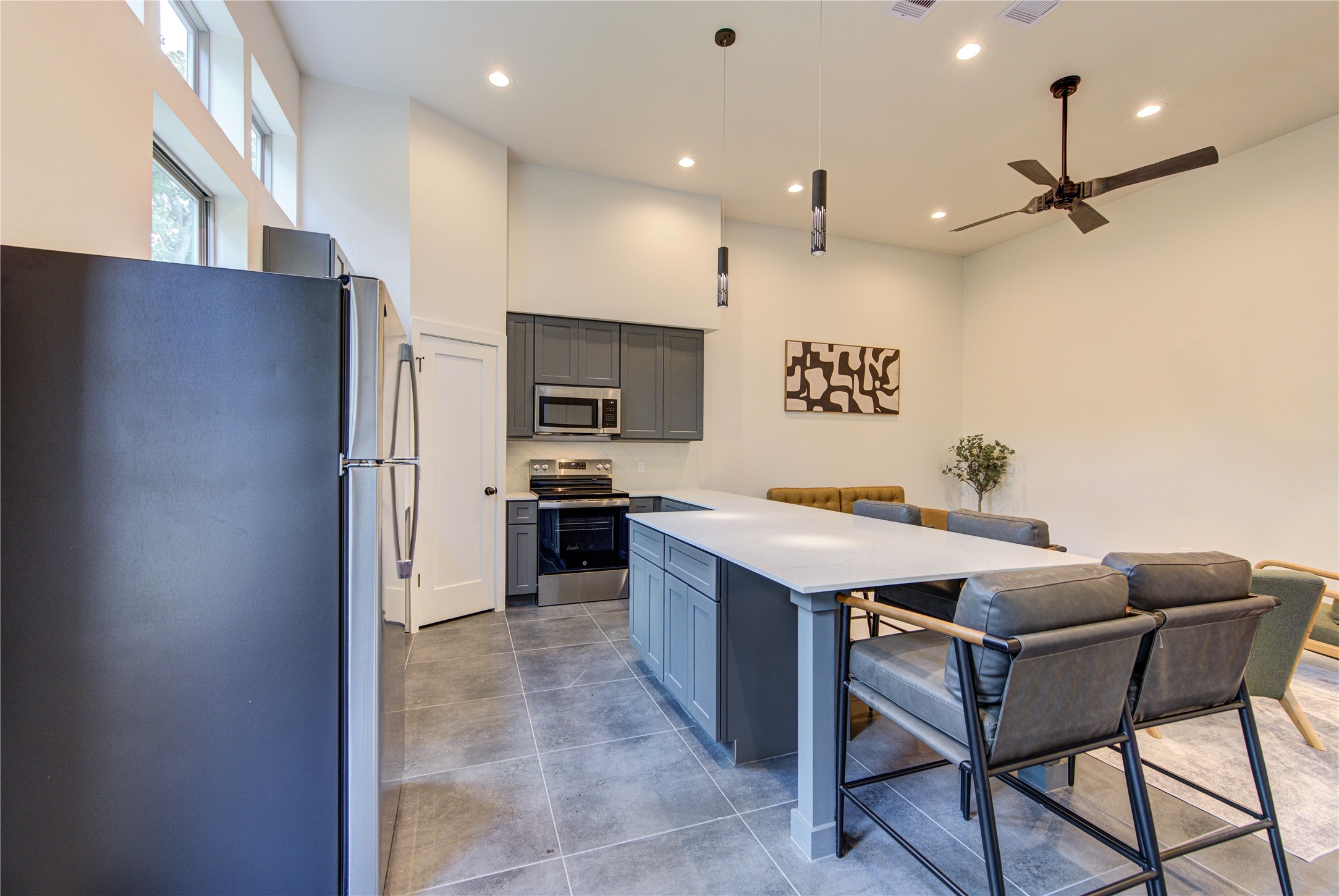 13102 Honey Suckle Ridge Lane Cypress, TX 77429 - Photo 11 of 48 a kitchen with a refrigerator a sink and chairs