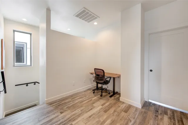 a view of hallway with wooden floor