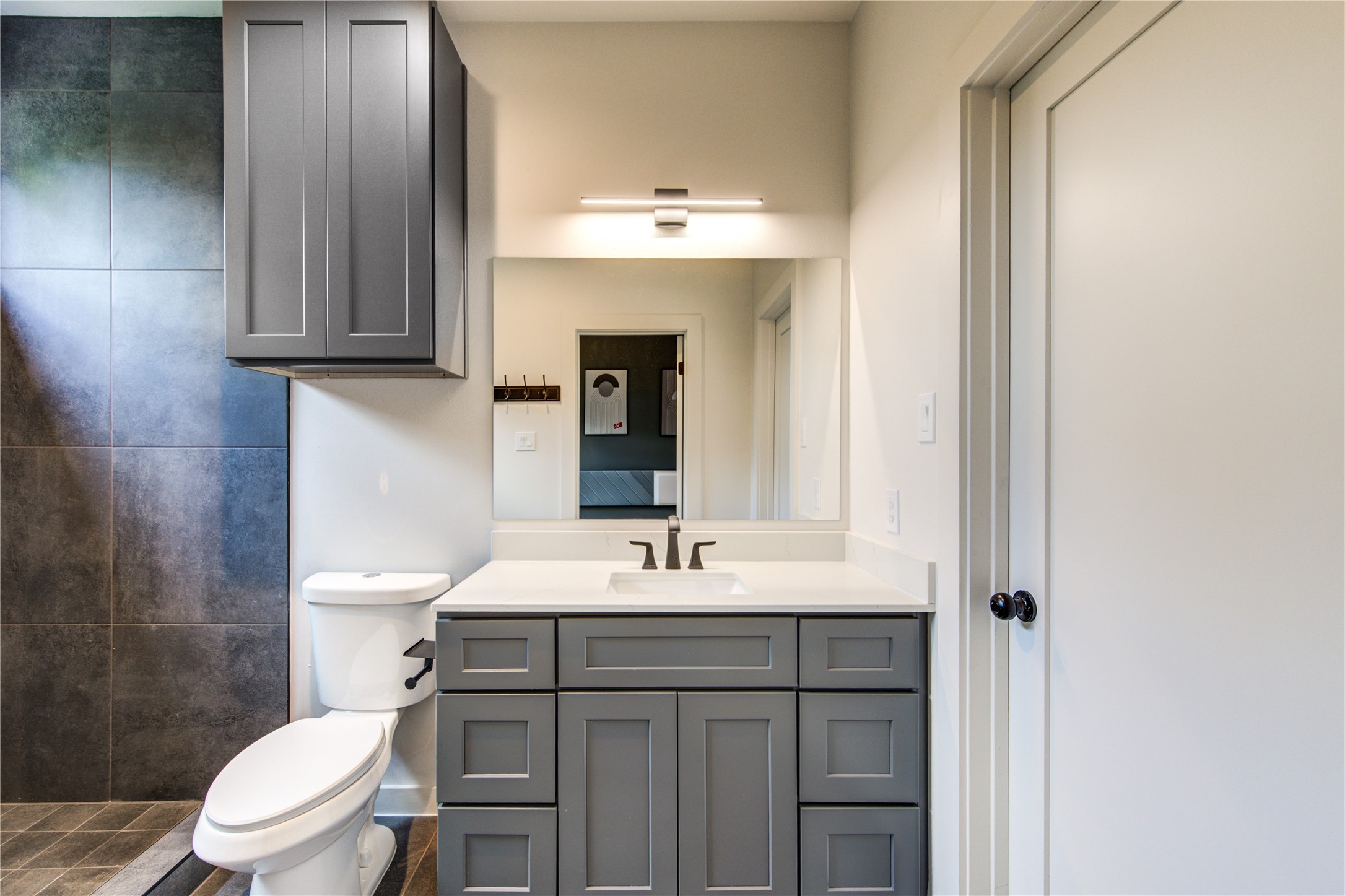 13102 Honey Suckle Ridge Lane Cypress, TX 77429 - Photo 24 of 48 a bathroom with a sink vanity mirror and toilet