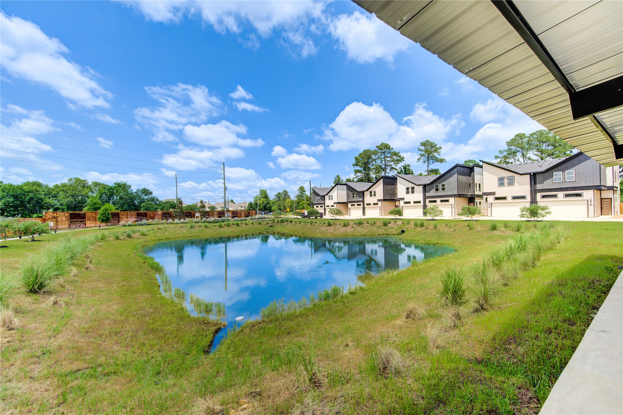13102 Honey Suckle Ridge Lane Cypress, TX 77429 - Photo 43 of 48 a view of a lake with a house in the background