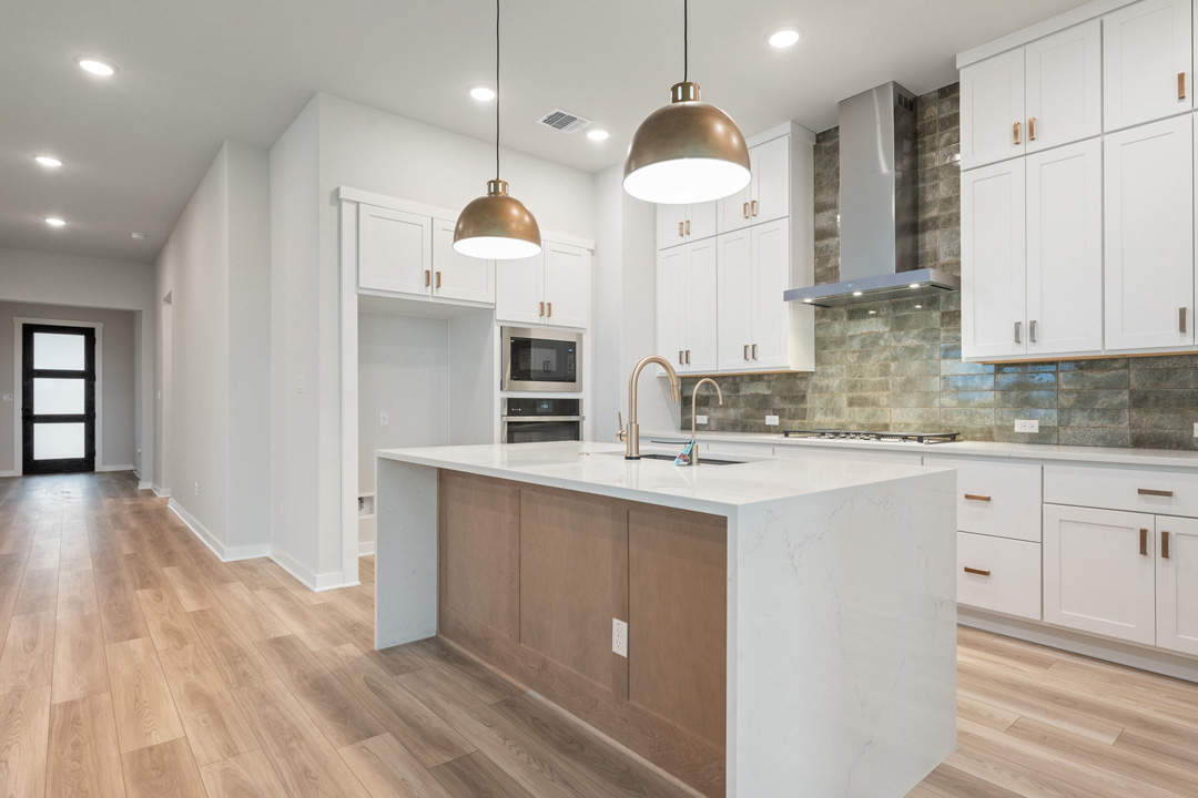 16201 Smithers Road Manor, TX 78653 - Photo 22 of 40 a kitchen with kitchen island a sink stainless steel appliances and cabinets