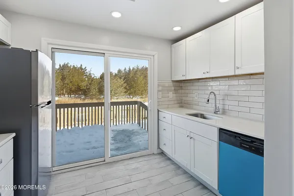 a kitchen with stainless steel appliances granite countertop a sink and a window