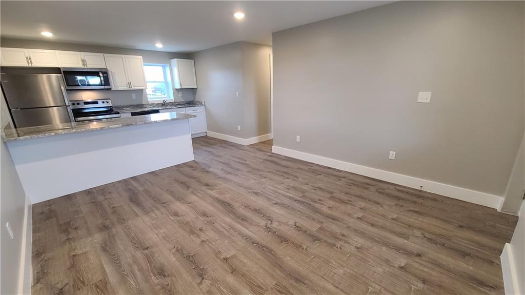 1331 Freeport Road Cheswick, PA 15024 - Photo 15 of 32 a large kitchen with stainless steel appliances a large counter top a stove and a wooden floors
