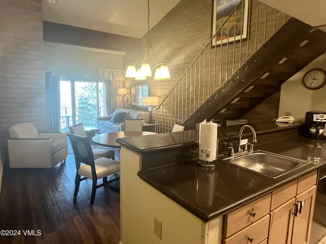 a kitchen with granite countertop a sink and a table