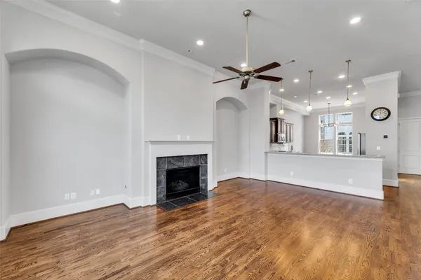 an empty room with a fireplace and fan