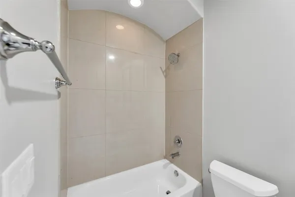 a bathroom with a bathtub and toilet