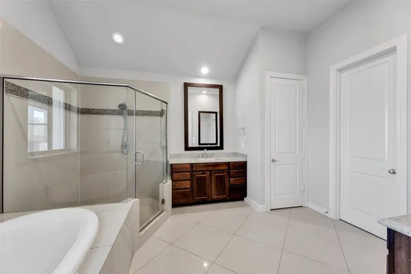 a bathroom with a tub shower and sink