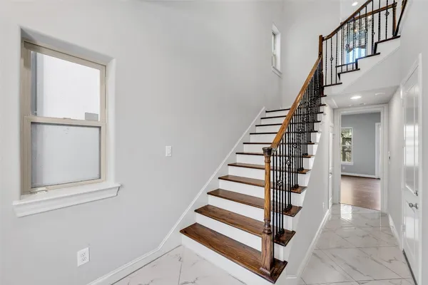 a view of entryway and hall with wooden floor
