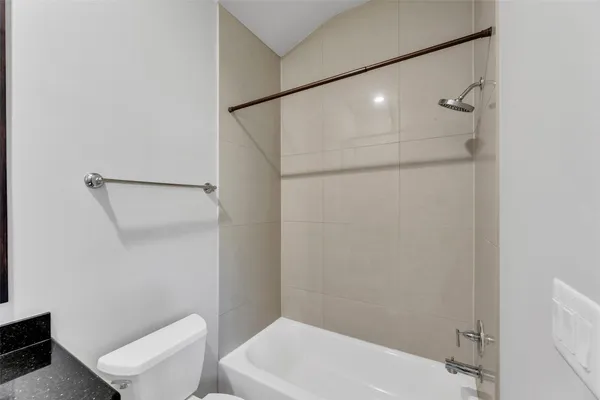 a bathroom with a shower and a toilet