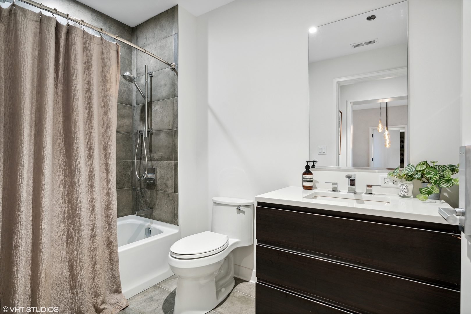 1400 West Monroe Street, Unit 4C Chicago, IL 60607 - Photo 13 of 15 a bathroom with a sink a toilet and shower