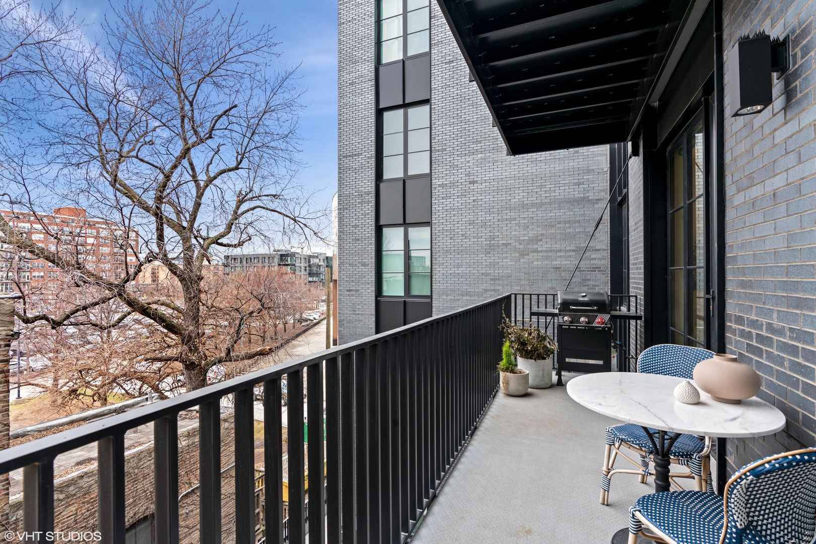 1400 West Monroe Street, Unit 4C Chicago, IL 60607 - Photo 14 of 15 a view of a balcony with chairs and a potted plant