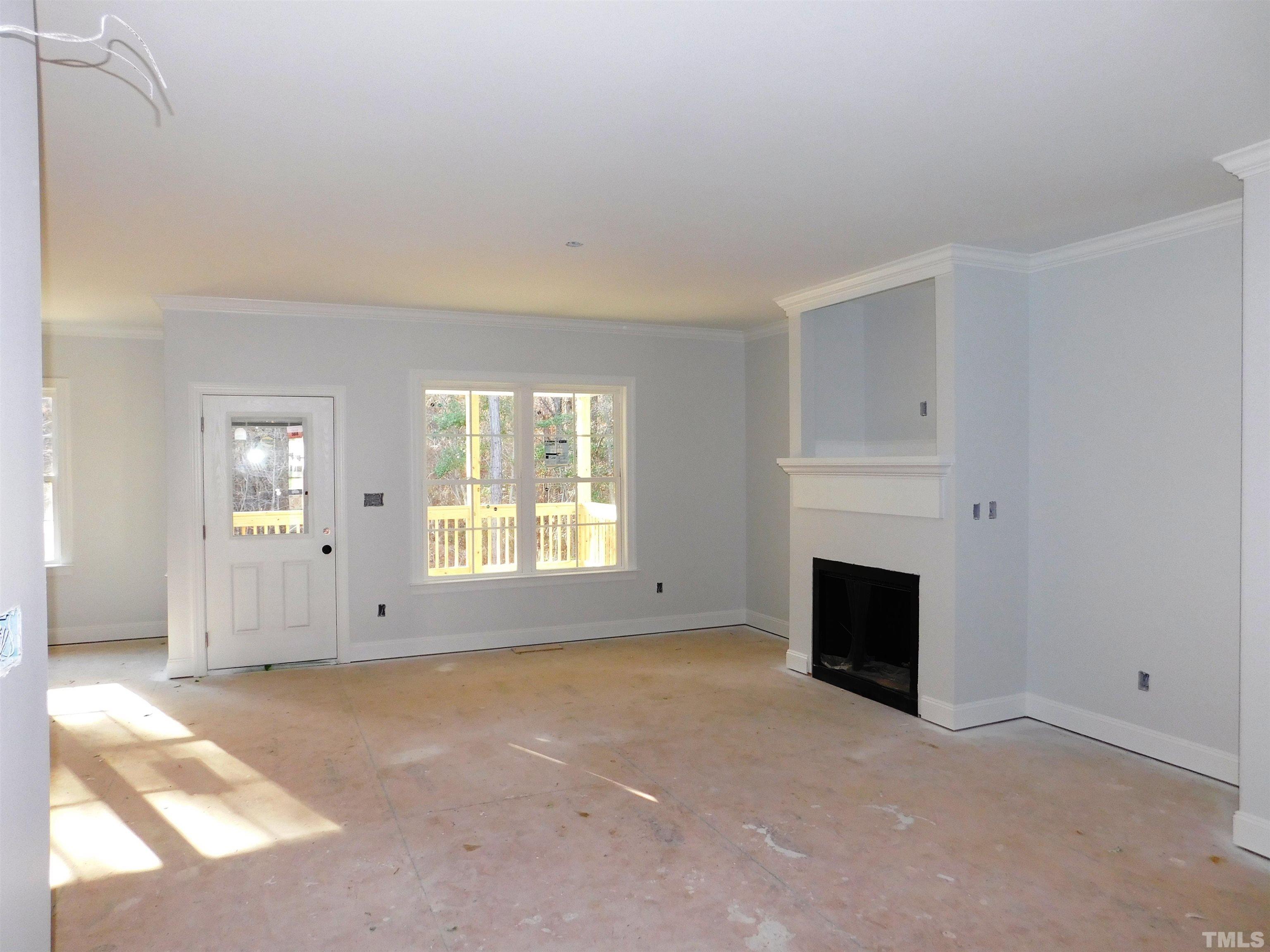 85 Yancey Road Zebulon, NC 27597 - Photo 2 of 10 a view of empty room with a fireplace