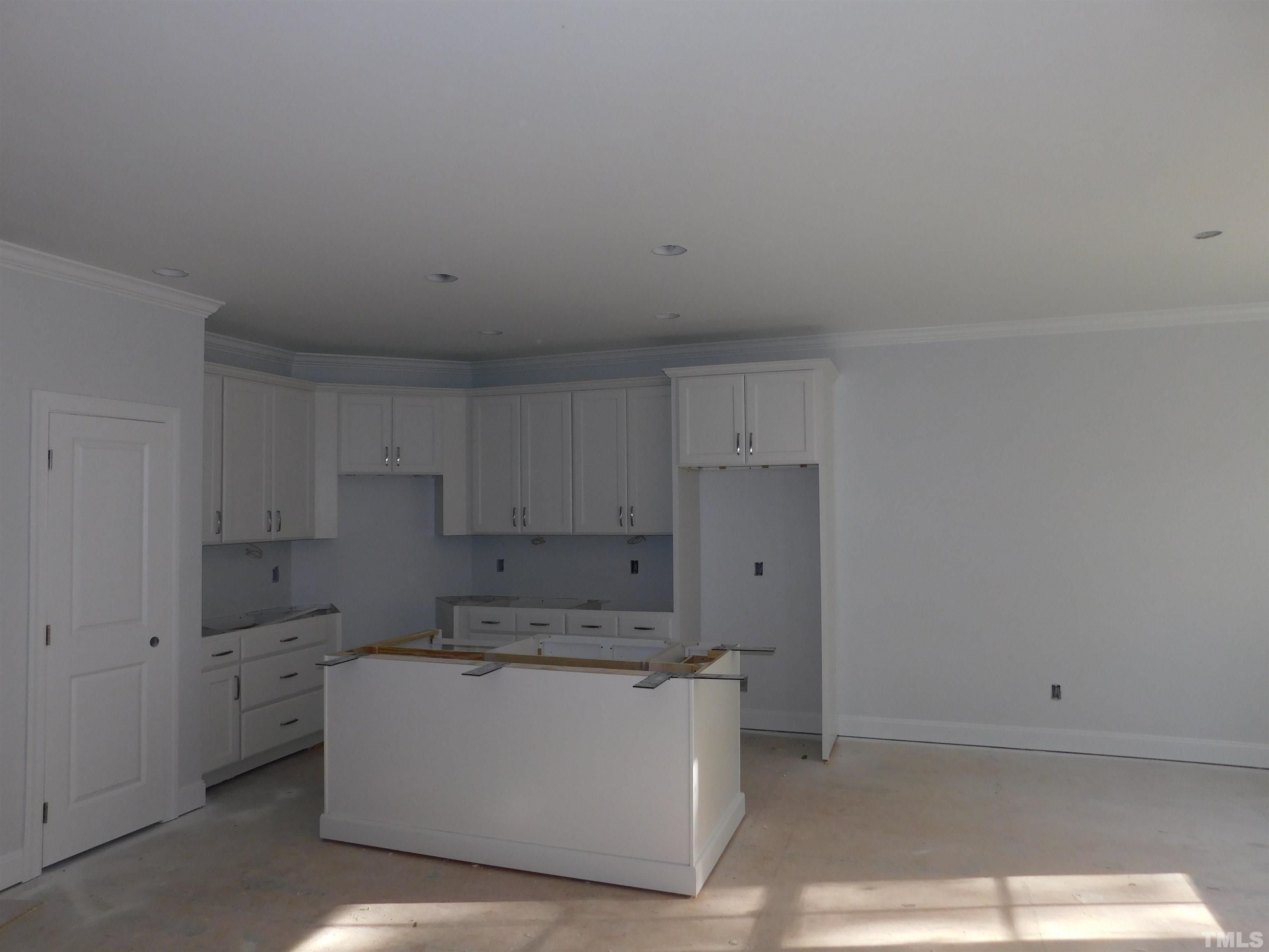 85 Yancey Road Zebulon, NC 27597 - Photo 6 of 10 a view of a kitchen with white cabinets
