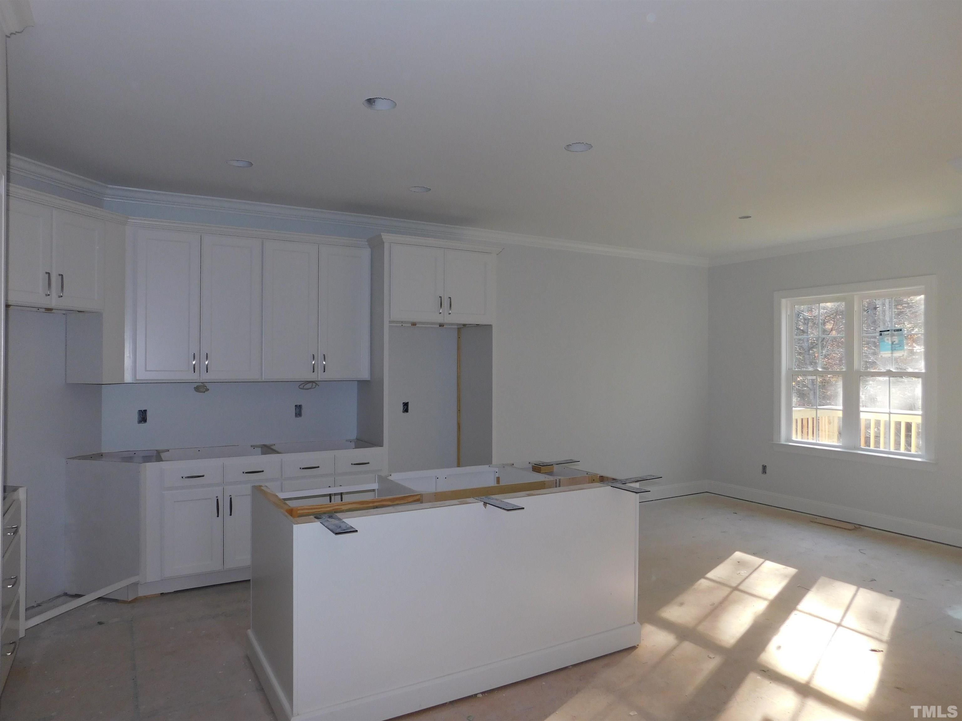 85 Yancey Road Zebulon, NC 27597 - Photo 7 of 10 a view of a kitchen with window and refrigerator