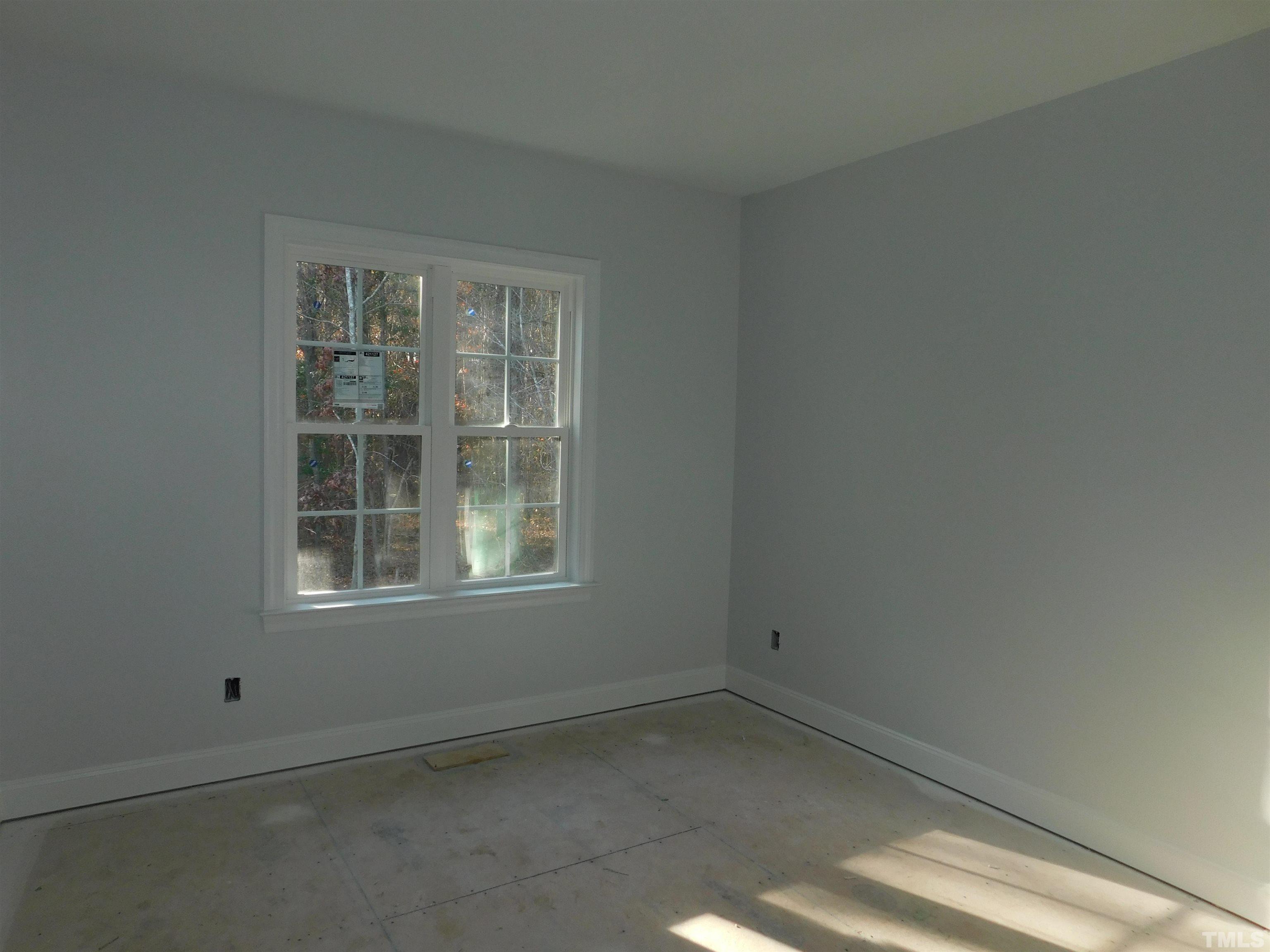 85 Yancey Road Zebulon, NC 27597 - Photo 8 of 10 an empty room with a window
