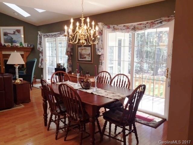 61 Bowman Ridge Road, Unit 5 Hendersonville, NC 28739 - Photo 11 of 24 a view of a dining room with furniture wooden floor and chandelier