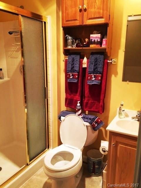61 Bowman Ridge Road, Unit 5 Hendersonville, NC 28739 - Photo 13 of 24 a bathroom with a toilet and a shower