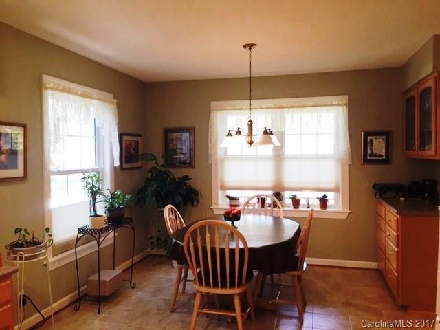 61 Bowman Ridge Road, Unit 5 Hendersonville, NC 28739 - Photo 8 of 24 a view of a dining room with furniture window and outside view