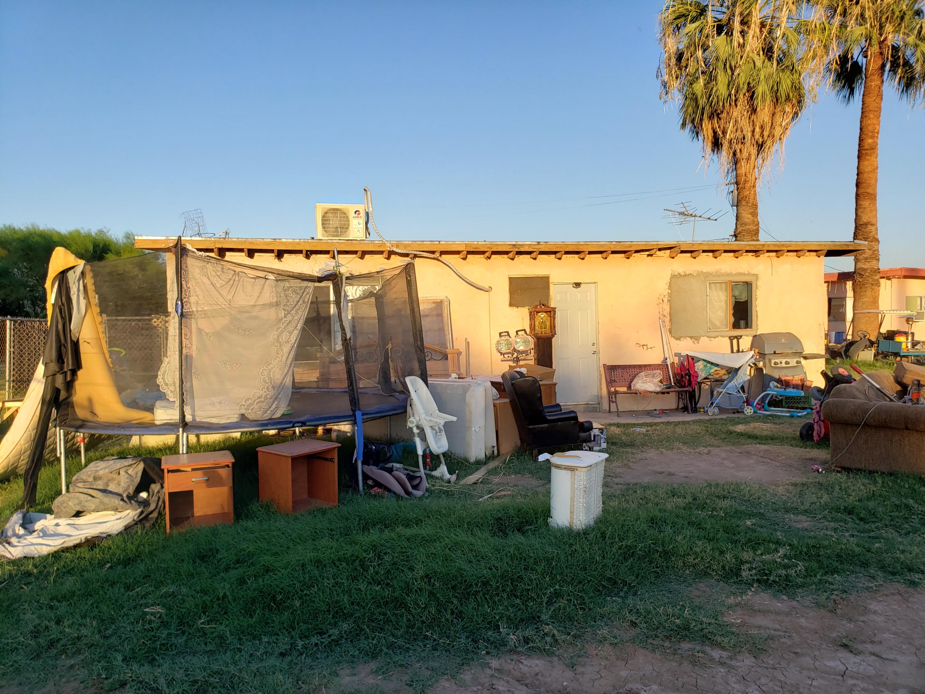 2139 Thomas Road Blythe, CA 92225 - Photo 9 of 9 a view of a swimming pool with a lawn chairs under an umbrella