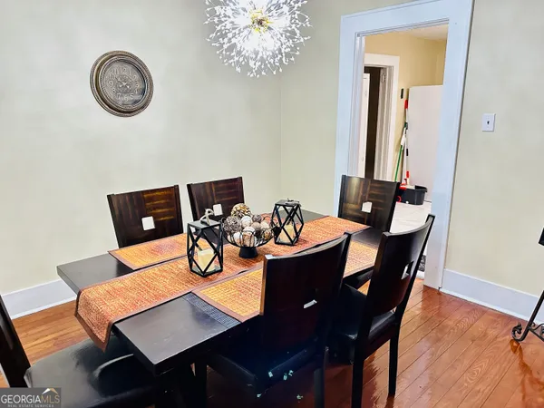 a view of a dining room with furniture and wooden floor