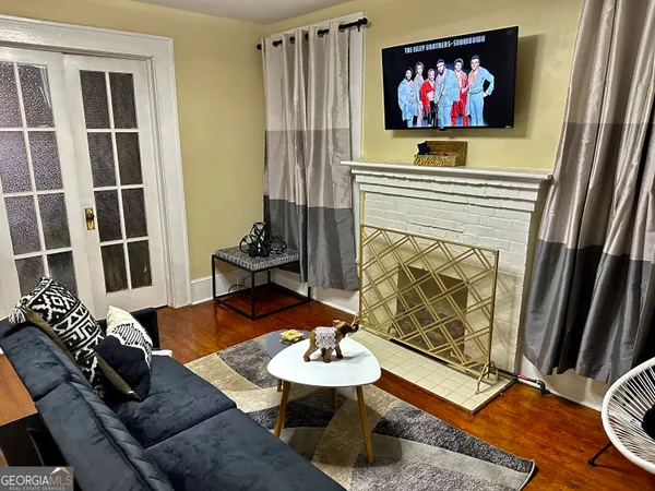 a living room with furniture a fireplace and a flat screen tv