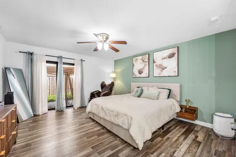 a bedroom with a bed and a flat screen tv