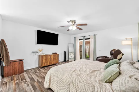 a bedroom with a bed and a chandelier