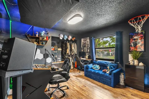 a view of a workspace with furniture and a flat screen tv