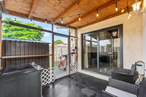 a view of a house with a backyard and wooden fence