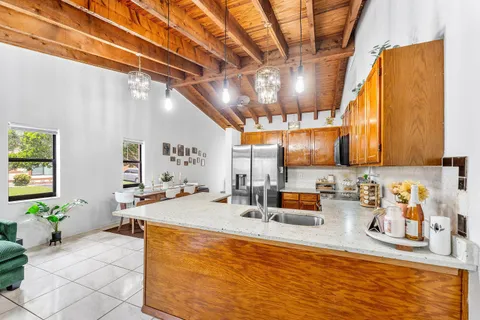 a kitchen with a sink and a refrigerator