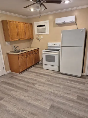 a kitchen with stainless steel appliances granite countertop a stove a sink and a refrigerator