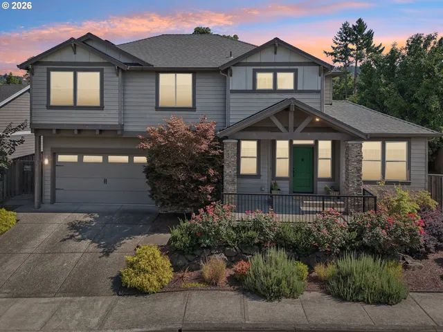 a front view of a house with a yard and outdoor seating