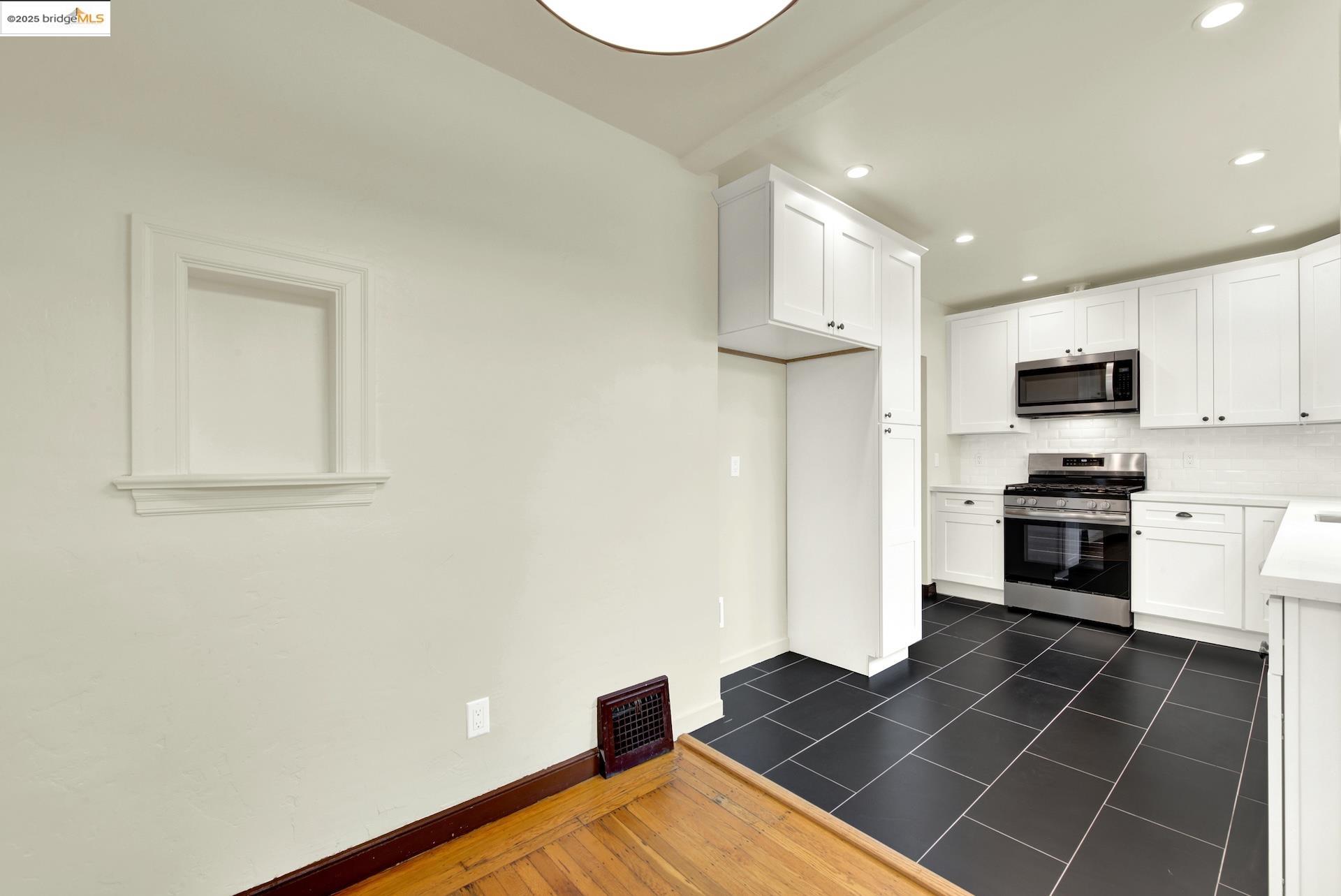 971 34th Street Richmond, CA 94805 - Photo 16 of 58 Kitchen featuring stainless steel appliances, recessed lighting, decorative backsplash, white cabinets, and light countertops