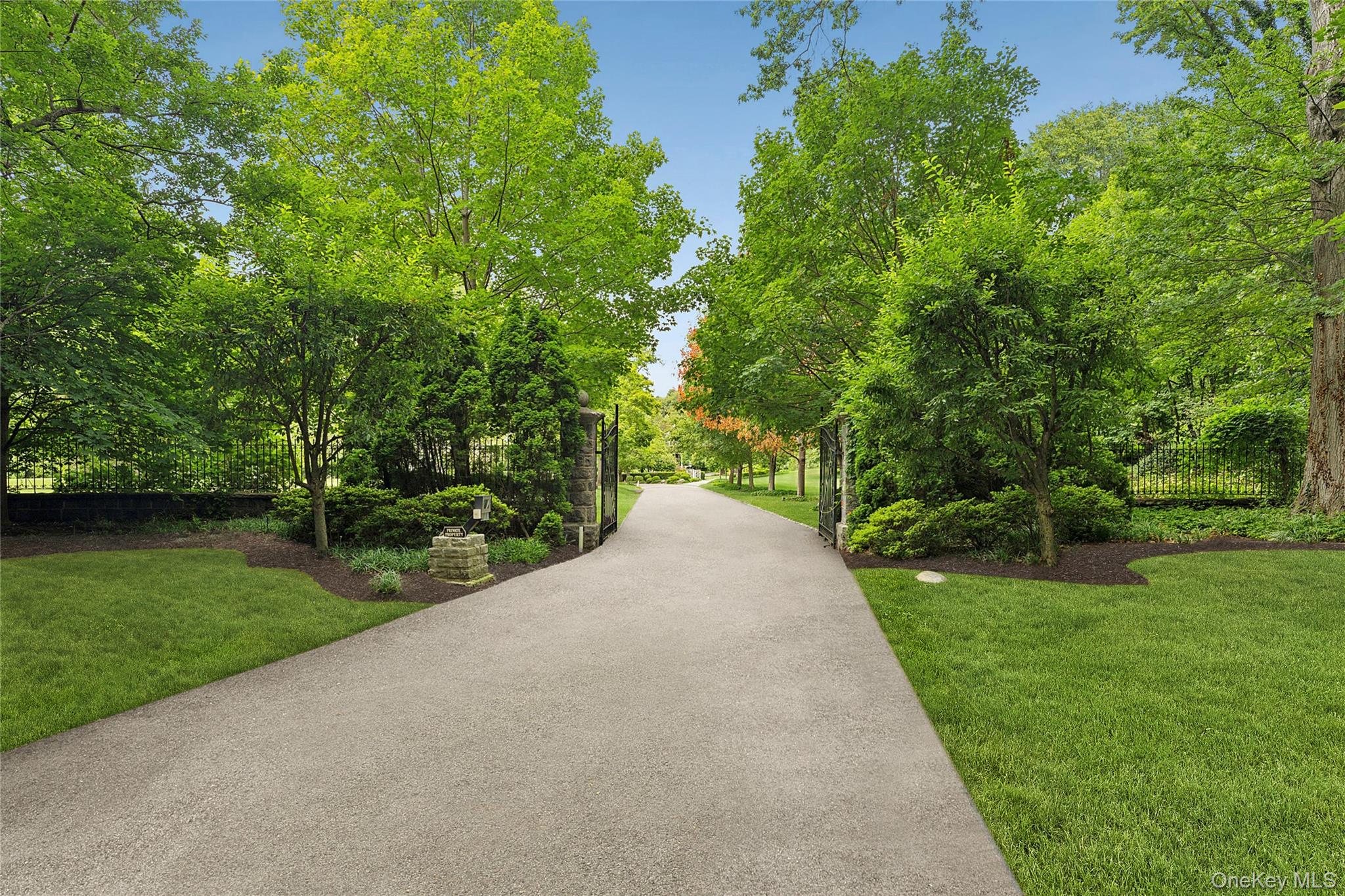 45 Cedar Lane Sands Point, NY 11050 - Photo 5 of 18 a view of a road with a yard