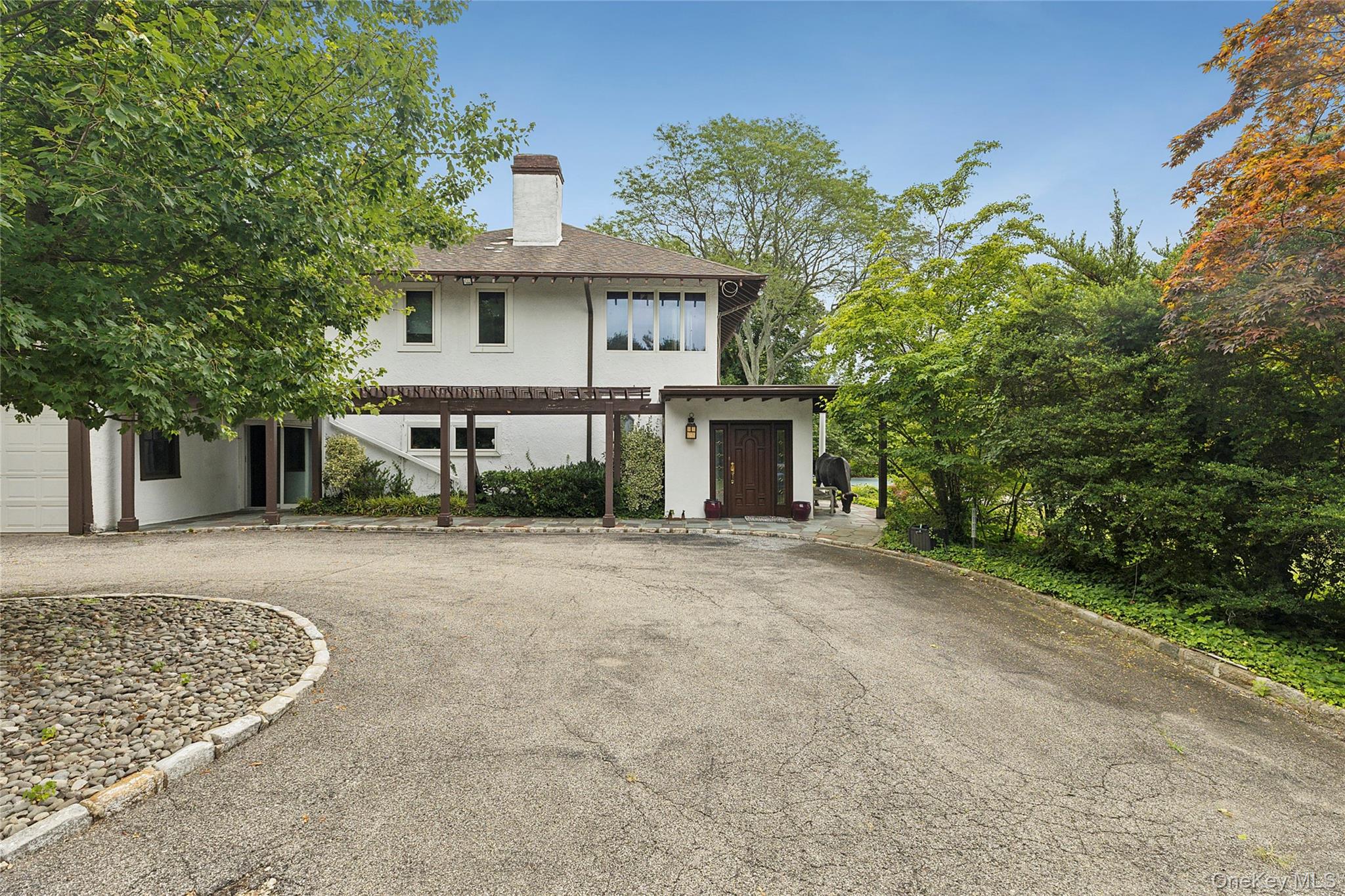 45 Cedar Lane Sands Point, NY 11050 - Photo 7 of 18 front view of a house with a street