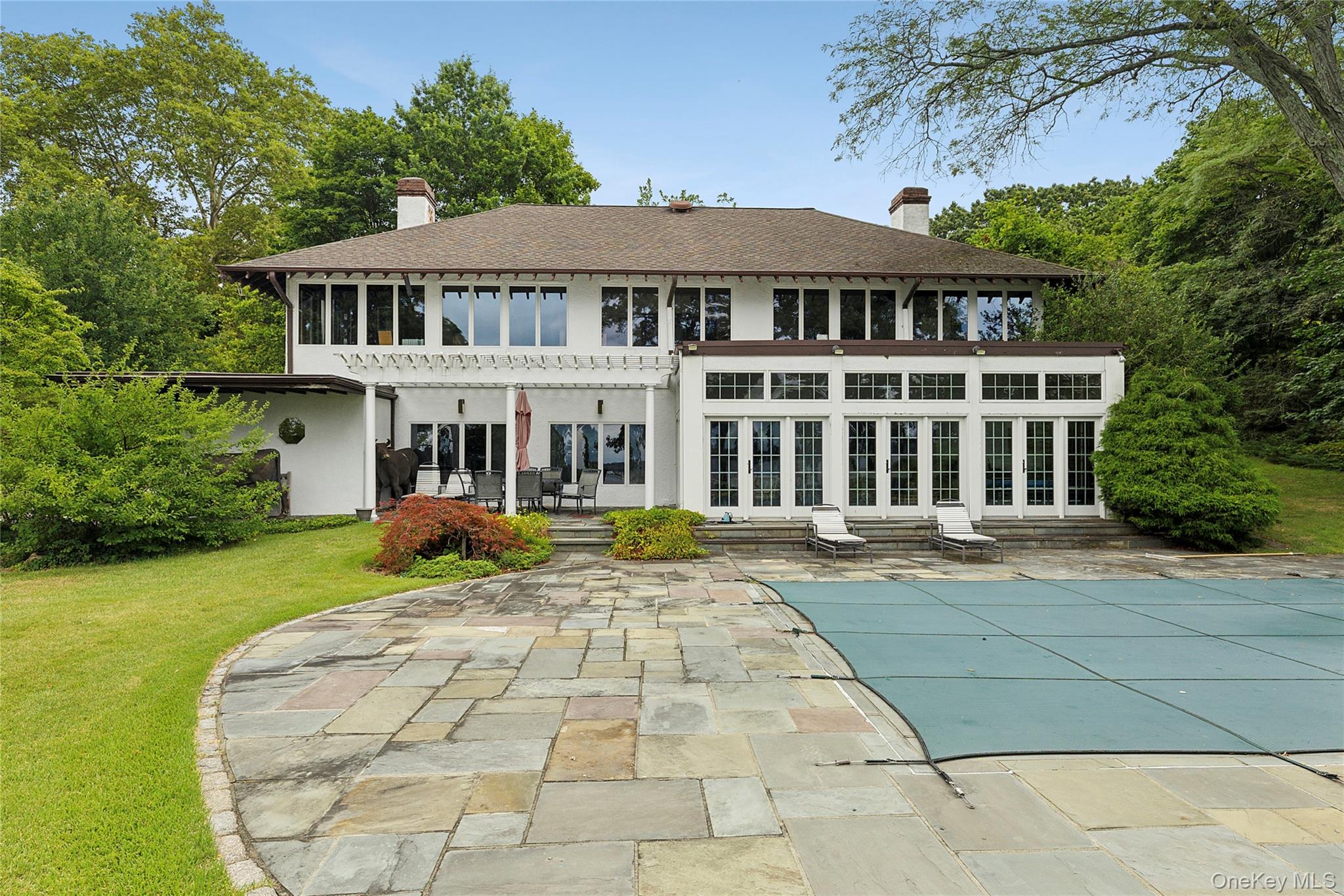 45 Cedar Lane Sands Point, NY 11050 - Photo 8 of 18 a view of a white house with a yard