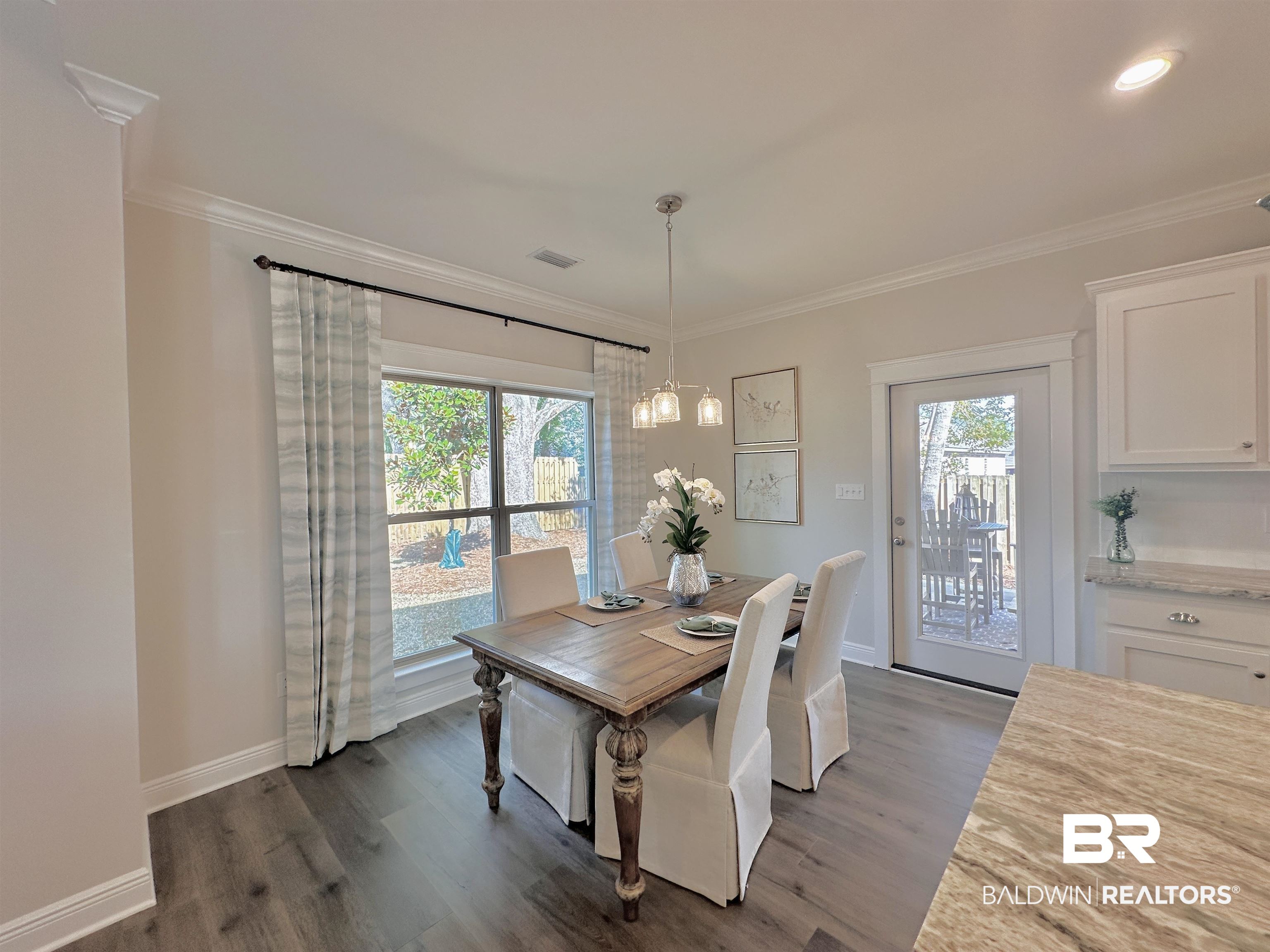 691 Kitfox Avenue Fairhope, AL 36532 - Photo 9 of 42 Dining area with hardwood / wood-style flooring, ornamental molding, and a wealth of natural light