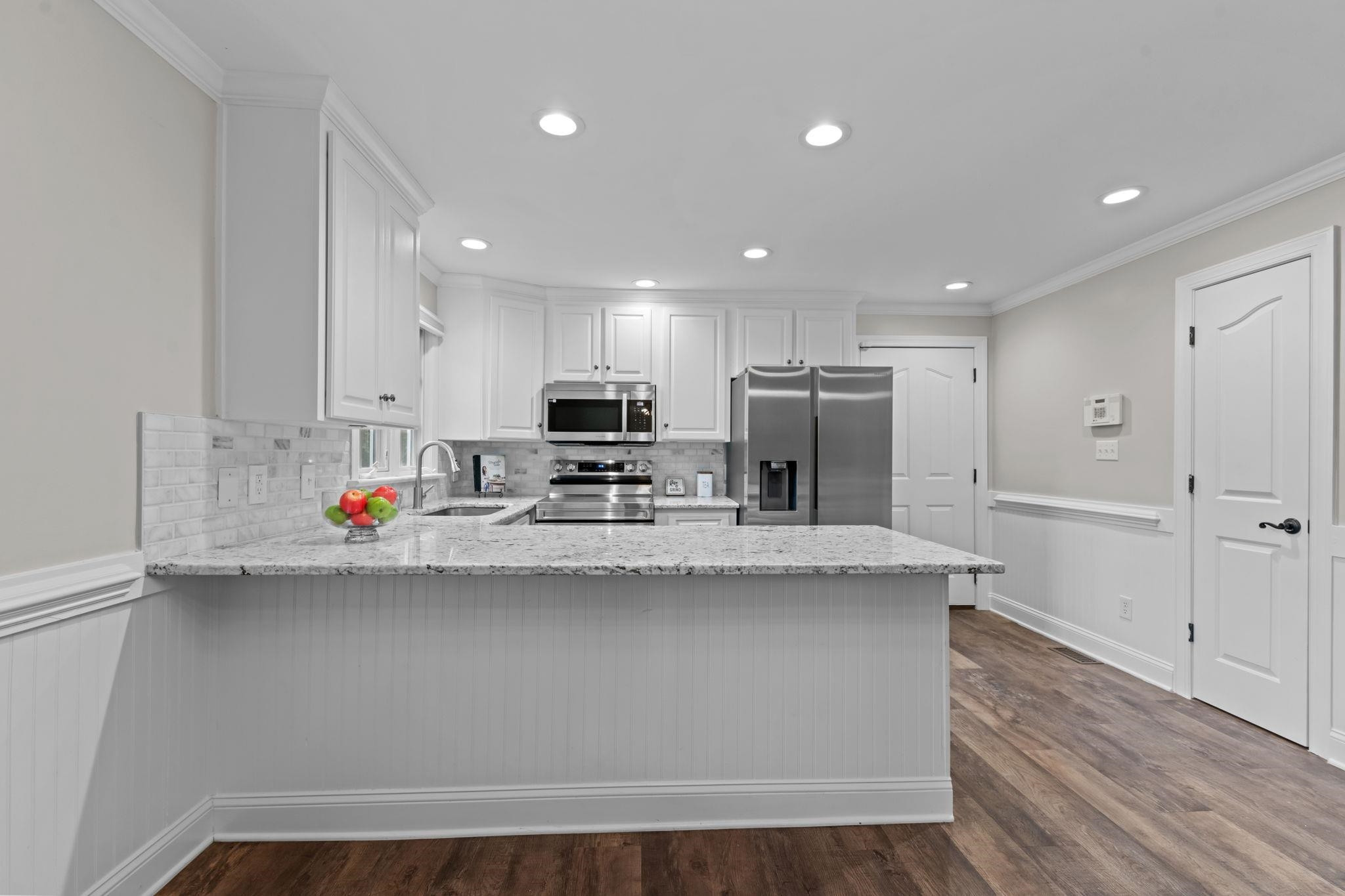 409 Husketh Road Youngsville, NC 27596 - Photo 11 of 29 a kitchen with stainless steel appliances a sink stove refrigerator and cabinets